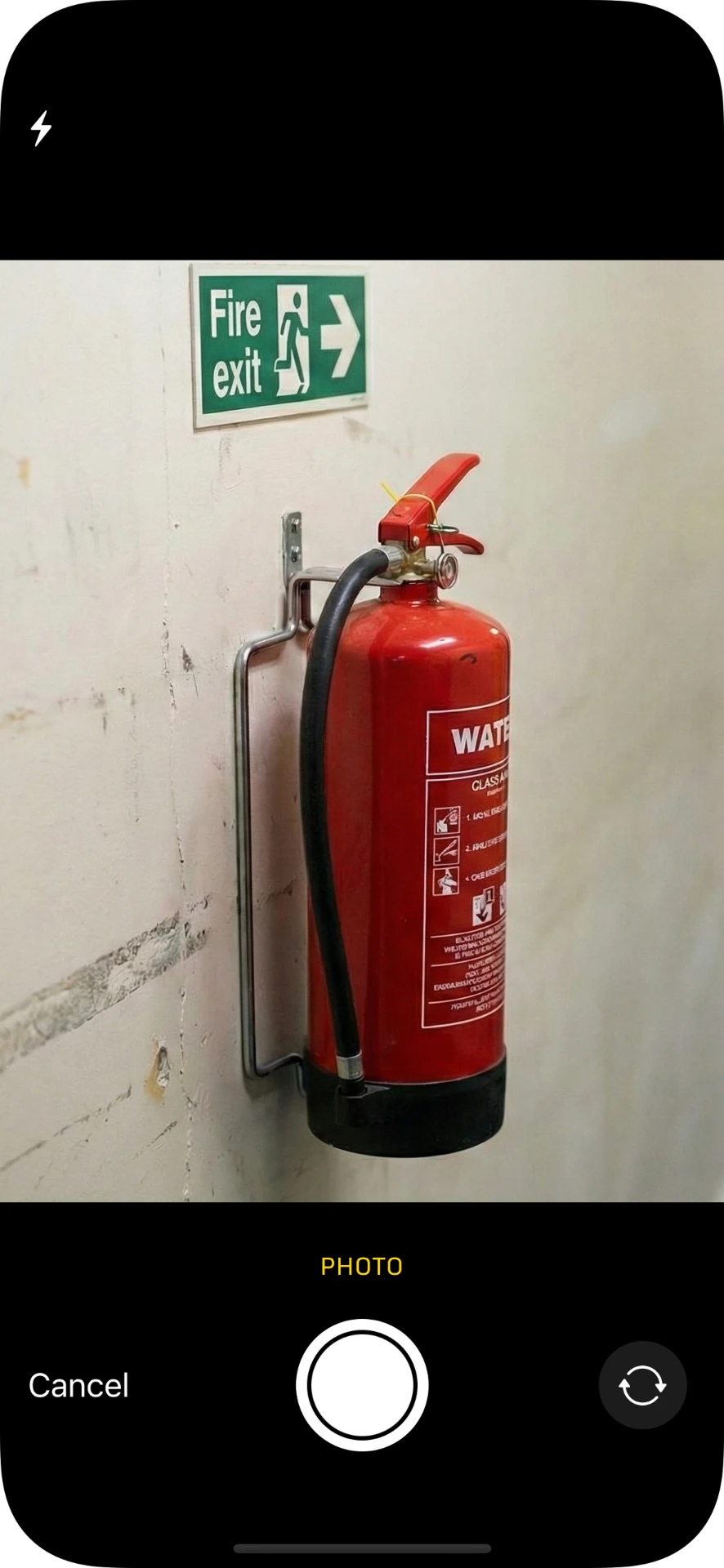 Camera view photographing a fire extinguisher and fire exit sign